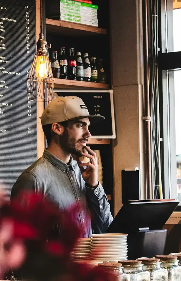 Cafe owner talking at the counter