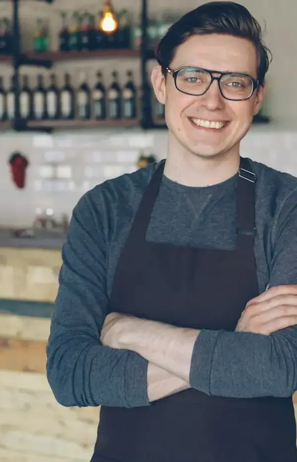 Cafe owner smiling behind the counter